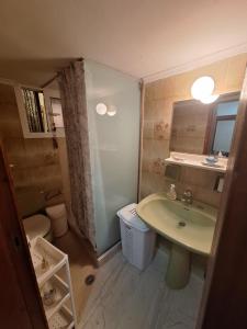 a bathroom with a sink and a toilet at Valerias house in Aígio