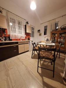 a kitchen with a table and chairs in a room at Valerias house in Aígio +10 photos
