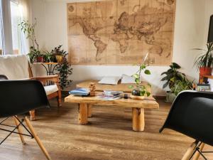 a living room with a table and a map on the wall at Hostería Aonikenk in Ushuaia