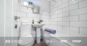 a white bathroom with a sink and a bath tub at Modern 2 Bed Apartment on Edge of City Centre, 2xFREE Private Parking, Ground Floor & Private Entrance in Quiet Neighbourhood in Peterborough