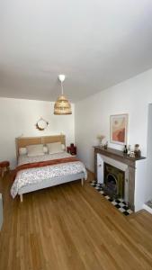 a bedroom with a bed and a fireplace at La Léonardine à deux pas du château royal in Amboise +14 photos