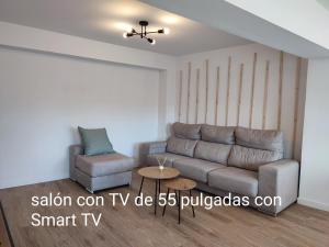 a living room with a couch and a chair at O Paseo, 5 estrellas. in Puentedeume