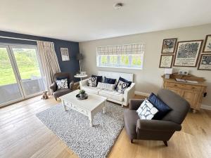 a living room with a couch and a table at Ocean Retreat - Part of the The Bay Filey Holiday Village with pool, gym and direct beach access, pub, restaurant, tennis and meadows walks in Filey