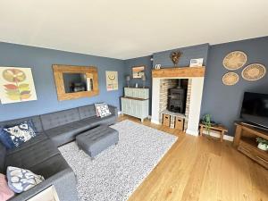 a living room with a couch and a fireplace at Ocean Retreat in Filey