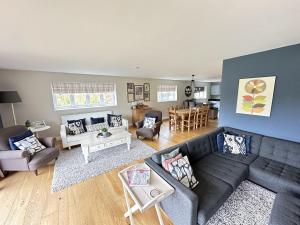 a living room with a couch and a table at Ocean Retreat - Part of the The Bay Filey Holiday Village with pool, gym and direct beach access, pub, restaurant, tennis and meadows walks in Filey