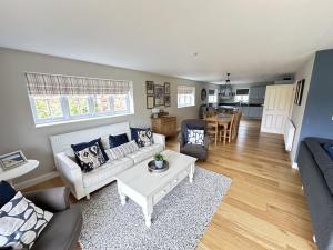 a living room with a couch and a table at Ocean Retreat - Part of the The Bay Filey Holiday Village with pool, gym and direct beach access, pub, restaurant, tennis and meadows walks in Filey +48 photos