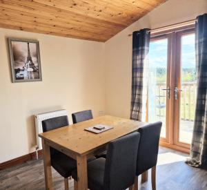 a dining room with a wooden table and chairs at Cleish 7 With Private Hot Tub - Fife - Loch Leven - Lomond Hills - Pet Friendly in Kelty