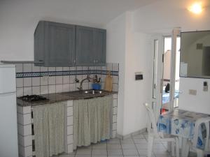 a kitchen with a sink and a counter top at L'Isolana Case Vacanza Alloro 2 in Ponza +4 photos