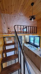 a staircase in a cabin with a kitchen and a sink at HAN Tiny House in Akcaabat