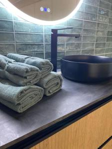 a bathroom with towels on a counter and a sink at Casa con piscina interior en Tamariu, Calella de Palafrugell in Palafrugell