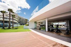 a large building with a gym on the side of it at Apartament Infinity View in Arenales del Sol