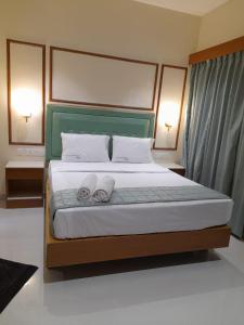 Ένα ή περισσότερα κρεβάτια σε δωμάτιο στο Hotel Harshanaa Elite