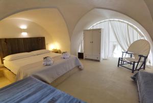 Postel nebo postele na pokoji v ubytování Masseria Verbena suites + 67 fotografií