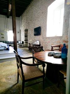 a room with a table and chairs and a room with a bed at Keresbino Hydra Manor House in Hydra