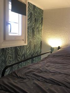 a bedroom with a bed next to a window at Studio cabine GRUISSAN PLAGE DU GRAZEL in Gruissan