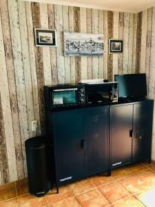 a room with two microwaves on top of a counter at Studio cabine GRUISSAN PLAGE DU GRAZEL in Gruissan
