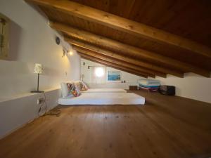 a bedroom with two beds in a room with wooden ceilings at Kleopatra Sweet Home in Symi