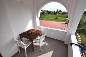 a dining room with a table and chairs and a window at Zennova #61, Boutique Studio in Nikiti in Nikiti