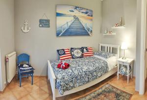 a bedroom with a bed and a picture of a pier at Villa DolceVita in Fregene