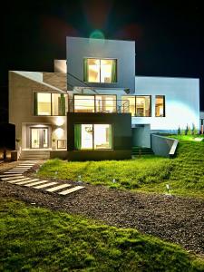 a large house with lights on in front of it at Casa Alma in Piatra Neamţ
