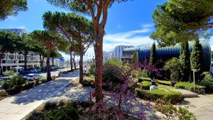 a street in a city with trees and flowers at Studio tout équipé vue sur Port in La Grande-Motte