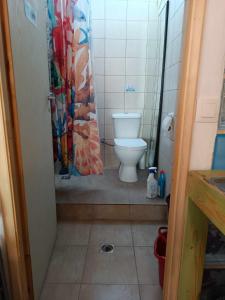 a bathroom with a toilet and a shower curtain at BUENo in Skiathos Town