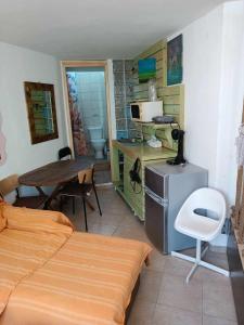 a bedroom with a bed and a desk and a table at BUENo in Skiathos Town