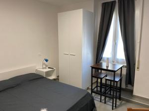 een slaapkamer met een bed, een bureau en een raam bij Venti di mare in Termoli