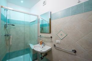 a bathroom with a sink and a shower at Casa Hermes in Atrani +40 photos