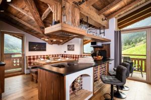 a kitchen with a stove and a fireplace at Alpen Chalet Wohnung "Rosa" in Zellberg