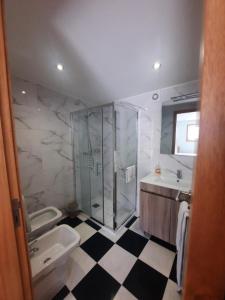 a bathroom with a shower and a toilet and a sink at Casa Velha in Matosinhos