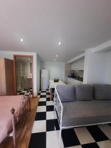 a living room with a couch and a bed at Casa Velha in Matosinhos