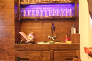 a kitchen with a sink and a shelf with glasses at Refresh Club wellness Ostrava in Poruba