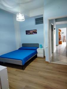 a blue bedroom with a bed in a room at MareFuori in Giardini Naxos