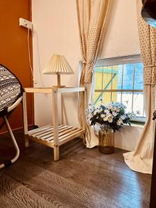 a room with a lamp and a chair and a window at Sen's Cozy House - 02 Queen beds - Kitchen - Center of Old Quarter, Hoan Kiem district in Hanoi +7 photos