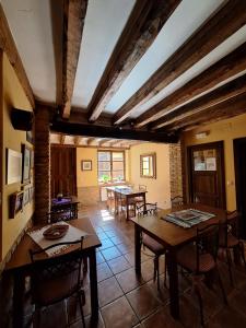 a dining room with tables and chairs in a room at Casa Rural El Encuentro in Villalón de Campos