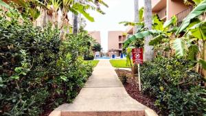 a sidewalk in front of a building with a no parking sign at Beachview 103 Condominium Condo in South Padre Island