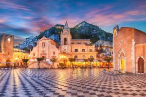 a view of a square in a city at night at Maria's guesthouse in Letojanni