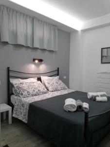 a bedroom with a bed with two towels on it at Maria's guesthouse in Letojanni