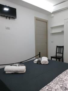 a room with a bed with towels on it at Maria's guesthouse in Letojanni