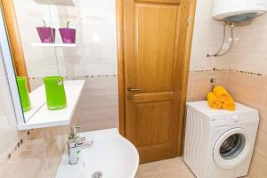 a bathroom with a washing machine and a washer at Апартаменты в Каменари in Kamenari