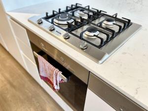 a stove top oven with a towel hanging from it at Apartment Mick in Melbourne
