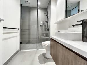 a bathroom with a shower and a toilet and a sink at Apartment Mick in Melbourne +5 photos