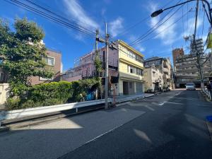 an empty street in a city with buildings at Shinjuku-STS Hostel in Tokyo