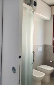 a small bathroom with a toilet and a sink at Residenza Acquaverde in Bibione Pineda