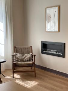 a living room with a chair and a fireplace at Santa Eulalia in Lugo