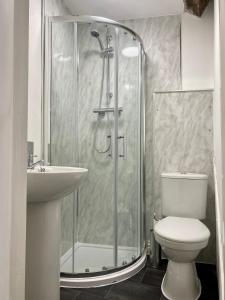 a bathroom with a shower and a toilet and a sink at JP Short Stays in Upton upon Severn