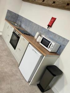 a kitchen with a counter top with a microwave at JP Short Stays in Upton upon Severn