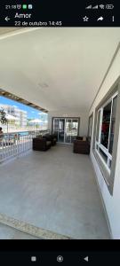 a large room with couches and chairs on a balcony at Apartamento Aconchego condomínio florida in Feira de Santana