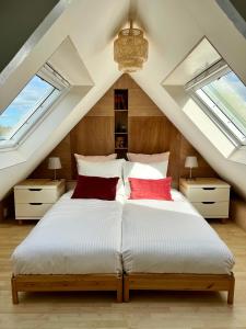 a bedroom with a large bed with two windows at Meadowview Unique private apartment near city centre in Amsterdam